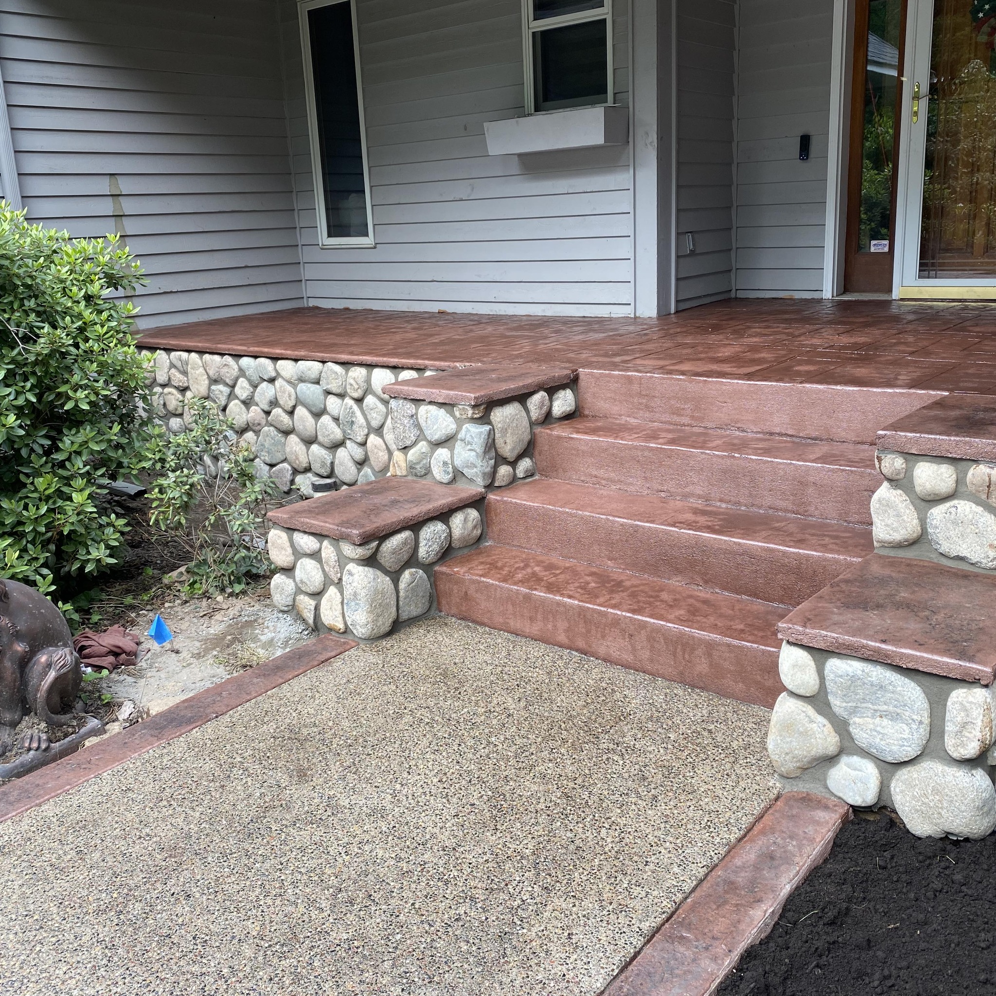 red concrete steps with stone inlay